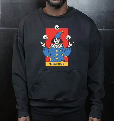 The Fool's Juggling Act - tarot card shirt, The Fool major arcana tee, vintage circus graphic, creepy clown apparel, juggling skulls design, dark academia streetwear, witchy aesthetic clothing, occult graphic fashion, macabre harlequin merch, retro mystic illustration - Cropped Sweatshirt